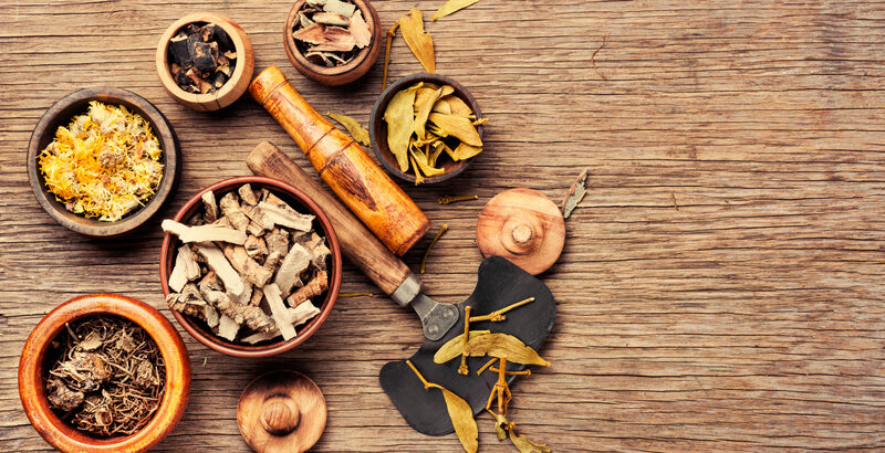 Natural herbal remedies and mortar used in naturopathic practice